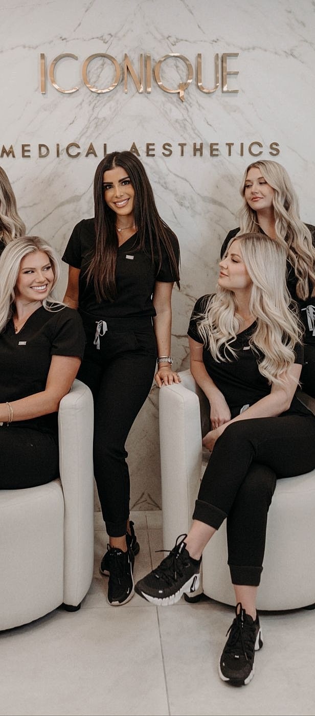 Aesthetic clinic team posing together professionally.