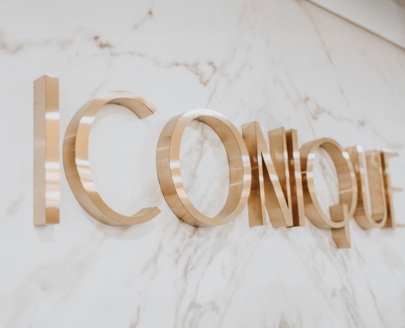 Gold lettering on a marble wall.